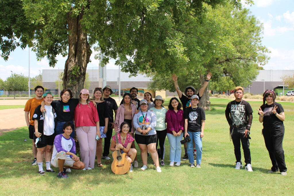 A group of people posing on grass